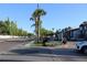 Palmera Pointe sign featuring mature palm trees along with street parking at 7927 Kosi Palm Pl # 201, Tampa, FL 33615