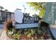 Prominent community sign for Palmera Pointe surrounded by landscaping and bushes at 7927 Kosi Palm Pl # 201, Tampa, FL 33615
