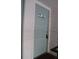 Condo unit 201's light blue entrance door and lockbox at 7927 Kosi Palm Pl # 201, Tampa, FL 33615