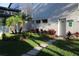Well-maintained exterior with lush landscaping and a brick-paved walkway leads to the laundry room entrance at 7927 Kosi Palm Pl # 201, Tampa, FL 33615