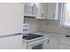 Kitchen has white cabinets and appliances at 7927 Kosi Palm Pl # 201, Tampa, FL 33615