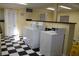 Bright laundry room with checkerboard floors and multiple washing machines for resident's use at 7927 Kosi Palm Pl # 201, Tampa, FL 33615