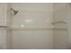 A tiled shower featuring tile surround, and chrome shower head at 7927 Kosi Palm Pl # 201, Tampa, FL 33615