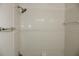 A tiled shower featuring tile surround, and chrome shower head at 7927 Kosi Palm Pl # 201, Tampa, FL 33615