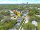 An attractive light blue two-story home surrounded by green trees with a city skyline in the background at 795 26Th N Ave, St Petersburg, FL 33704