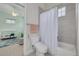 Bathroom features a shower/tub combo with white shower curtain, toilet, and view into the adjacent Bedroom at 795 26Th N Ave, St Petersburg, FL 33704