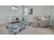 Charming Bedroom featuring a crib, gray rocking chair, decorative rug, and soft, natural lighting at 795 26Th N Ave, St Petersburg, FL 33704