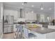 Bright kitchen features an island, granite countertops, stainless steel appliances and modern white cabinetry at 795 26Th N Ave, St Petersburg, FL 33704