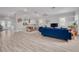 Open-concept living room with blue sofa, dining area, and a seamless flow into the modern kitchen at 795 26Th N Ave, St Petersburg, FL 33704