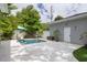 Backyard pool with ample deck space, greenery, and accessory building at 795 26Th N Ave, St Petersburg, FL 33704