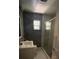 Modern bathroom with glass door shower, vanity, and tiled floors at 807 E Elm St, Tampa, FL 33604