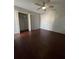 Spacious bedroom with a ceiling fan, closet, and unique slatwall accent at 807 E Elm St, Tampa, FL 33604