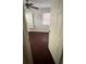 Bedroom with neutral paint, built-in storage, window, ceiling fan, and hard wood floors at 807 E Elm St, Tampa, FL 33604
