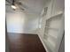 Bright bedroom features a ceiling fan, storage shelves, and slatwall paneling at 807 E Elm St, Tampa, FL 33604