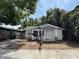 Charming single-story home with a light exterior, covered parking, and a tidy yard at 807 E Elm St, Tampa, FL 33604