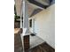 A covered front porch features brick columns and a fresh coat of white paint at 807 E Elm St, Tampa, FL 33604