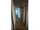 Hallway with neutral paint and hardwood flooring at 807 E Elm St, Tampa, FL 33604