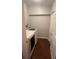 Functional laundry room with washer, dryer, storage, and hardwood floors at 807 E Elm St, Tampa, FL 33604