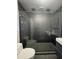 Sleek walk-in shower with black mosaic tiles and glass door at 807 E Elm St, Tampa, FL 33604