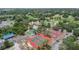 Aerial view of the clubhouse with tennis courts, pool, and golf course at 8135 Golf Club Ct, Hudson, FL 34667