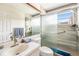 Bathroom features tiled walls and a sliding glass door shower at 8135 Golf Club Ct, Hudson, FL 34667