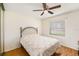 This bedroom features a metal headboard frame, wood flooring and a ceiling fan at 8135 Golf Club Ct, Hudson, FL 34667