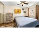 Cozy bedroom features a ceiling fan, wood-look flooring, and neutral wall color at 8135 Golf Club Ct, Hudson, FL 34667