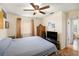 Bedroom features a ceiling fan, neutral color walls, closet, and a window at 8135 Golf Club Ct, Hudson, FL 34667