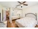 Bedroom features wood floors, sliding closet doors, and neutral colored walls at 8135 Golf Club Ct, Hudson, FL 34667