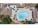 Aerial view of community pool with lounge chairs, umbrellas and patio area at 8135 Golf Club Ct, Hudson, FL 34667
