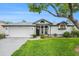 Charming single-story home with a well-manicured lawn, and a two car garage at 8135 Golf Club Ct, Hudson, FL 34667