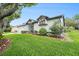 Attractive home with well-kept lawn, flower beds, and architectural accent window at 8135 Golf Club Ct, Hudson, FL 34667