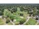 Elevated view of the golf course with mature trees and sand traps at 8135 Golf Club Ct, Hudson, FL 34667
