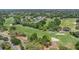 Aerial shot of lush green golf course with sand traps and mature landscaping at 8135 Golf Club Ct, Hudson, FL 34667
