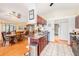 A kitchen overlooking the dining area, featuring wood cabinets, stainless steel appliances, and granite countertops at 8135 Golf Club Ct, Hudson, FL 34667