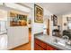 A partial view of a kitchen featuring granite countertops and a sink, with artwork on the walls at 8135 Golf Club Ct, Hudson, FL 34667
