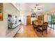 Bright kitchen and dining area with granite countertops, wooden cabinetry, and hardwood floors at 8135 Golf Club Ct, Hudson, FL 34667