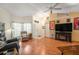 Inviting living area features hardwood floors, cozy seating, and lots of natural light at 8135 Golf Club Ct, Hudson, FL 34667