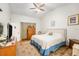 Main bedroom features a ceiling fan, carpet flooring, a closet and an ensuite bathroom at 8135 Golf Club Ct, Hudson, FL 34667