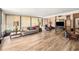 This room features wood-look tile flooring and a large seating area at 8135 Golf Club Ct, Hudson, FL 34667
