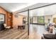 This room features wood-look tile flooring and a large seating area at 8135 Golf Club Ct, Hudson, FL 34667