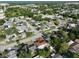 Aerial view showcasing a neighborhood with a mix of residential homes, lush greenery, and quiet streets at 8702 Congress St, Port Richey, FL 34668