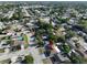 Aerial view showcases a neighborhood with lush greenery and diverse home styles near a body of water at 8702 Congress St, Port Richey, FL 34668