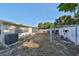 View of the backyard featuring an outdoor exercise station, a grass area, and a white privacy fence at 8702 Congress St, Port Richey, FL 34668