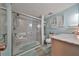 Updated bathroom featuring modern fixtures, glass-enclosed shower and vanity with sink at 8702 Congress St, Port Richey, FL 34668