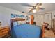 Cozy bedroom with plush carpeting, ceiling fan, and built-in closet for storage at 8702 Congress St, Port Richey, FL 34668