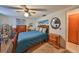 Bedroom featuring plush carpeting, ceiling fan and a dresser at 8702 Congress St, Port Richey, FL 34668