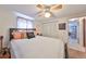 Bright bedroom features a comfortable bed, closet, and view into the living room at 8702 Congress St, Port Richey, FL 34668