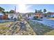 Charming single-story home with a manicured front yard, garden features, and a paved driveway at 8702 Congress St, Port Richey, FL 34668