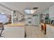 Charming kitchen with white cabinets, tile floors, an island and a view to living spaces at 8702 Congress St, Port Richey, FL 34668